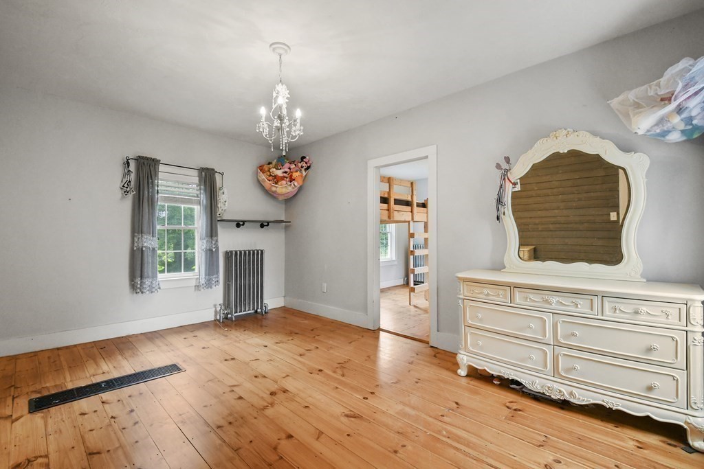 235 Manchaug Road Sutton, MA 01590 - Photo 29 of 41 a view of an empty room with wooden floor and a window