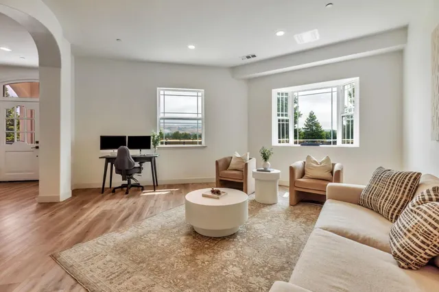a dining room with furniture and window