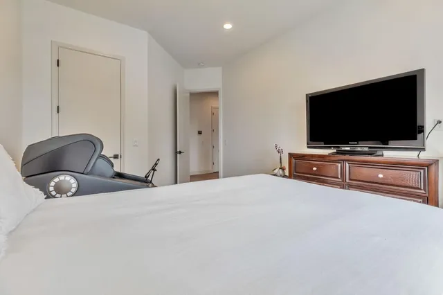 a bathroom with a sink a toilet and a large mirror