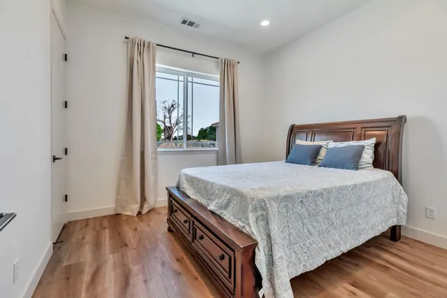 a large white kitchen with a large window
