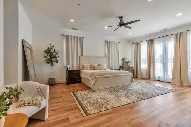 a view of a workspace with furniture and wooden floor