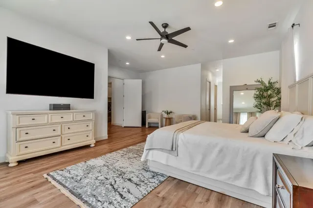 a bed room with a bed and a refrigerator