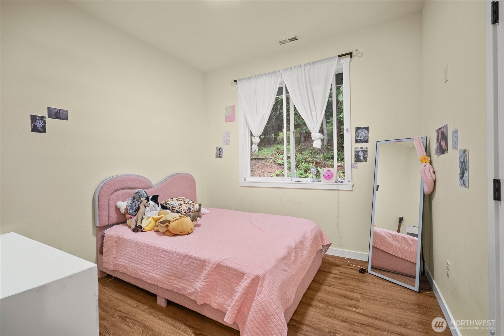 23 Spring Court Bellingham, WA 98229 - Photo 23 of 38 a bedroom with a bed and wooden floor