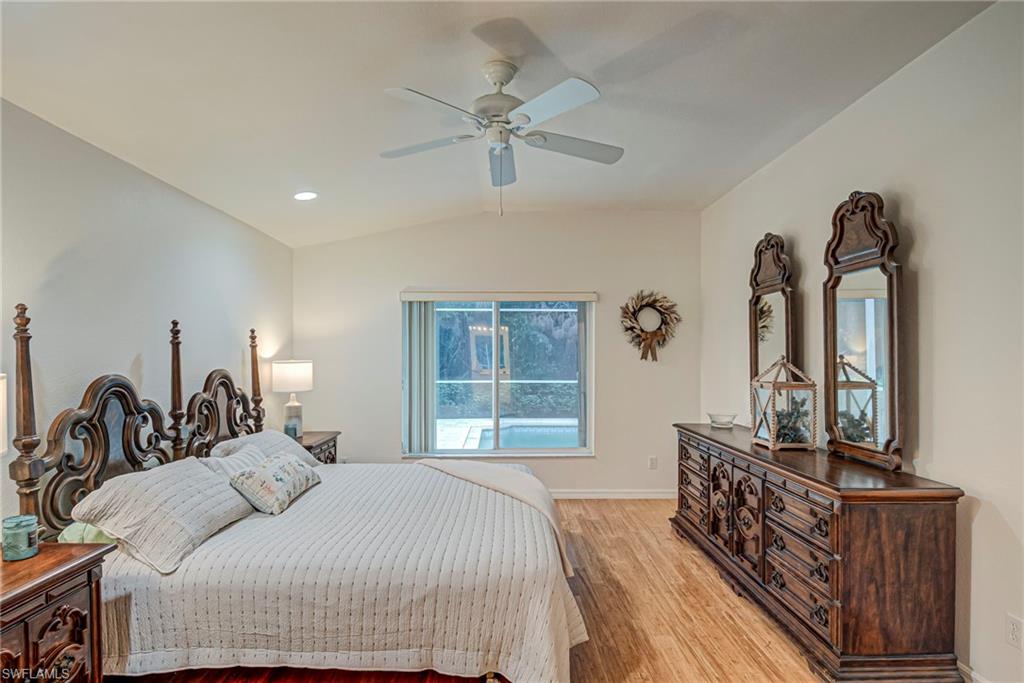 7809 Stratford Drive Naples, FL 34104 - Photo 11 of 47 a bedroom with a large bed and a dresser