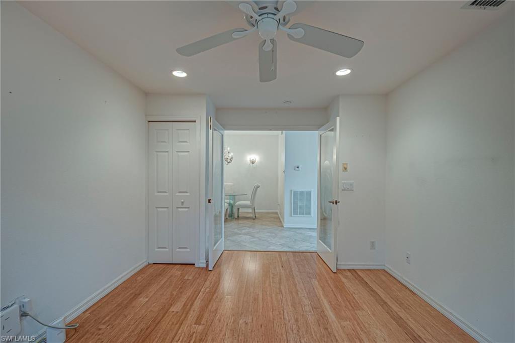 7809 Stratford Drive Naples, FL 34104 - Photo 16 of 47 a view of wooden floor and a chandelier fan in a room