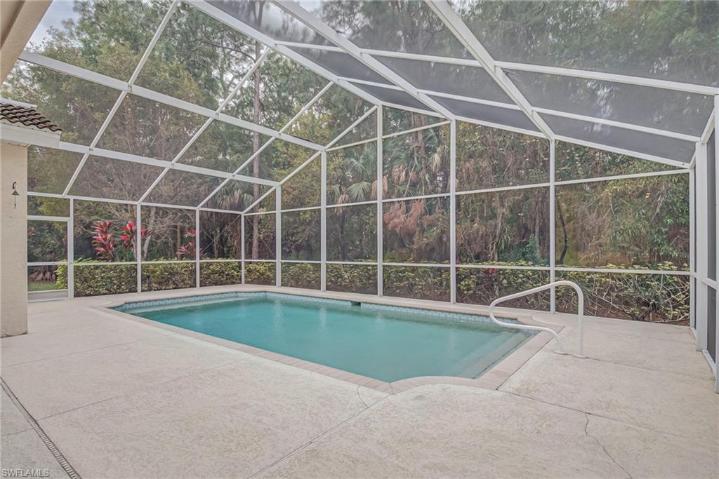 7809 Stratford Drive Naples, FL 34104 - Photo 24 of 47 a view of a swimming pool with a yard
