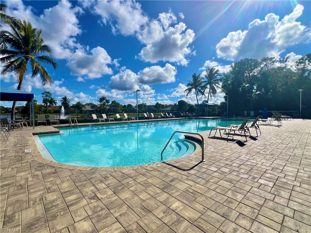 7809 Stratford Drive Naples, FL 34104 - Photo 27 of 47 a view of a swimming pool with a yard and sitting area