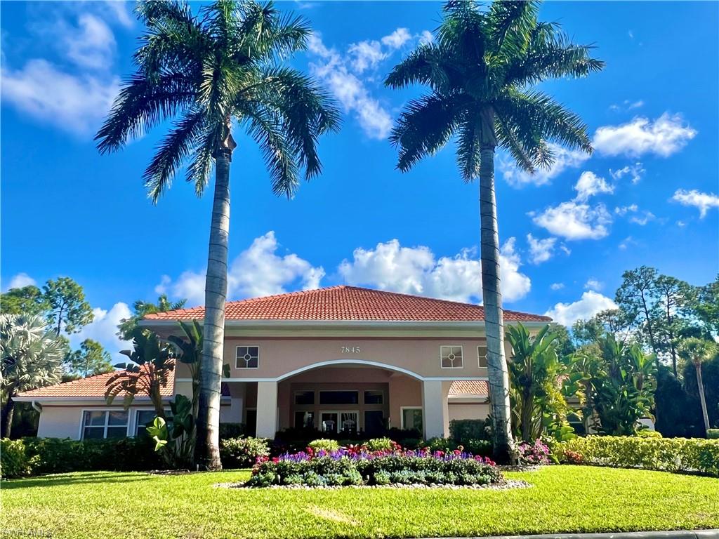7809 Stratford Drive Naples, FL 34104 - Photo 39 of 47 a front view of a house with yard and green space