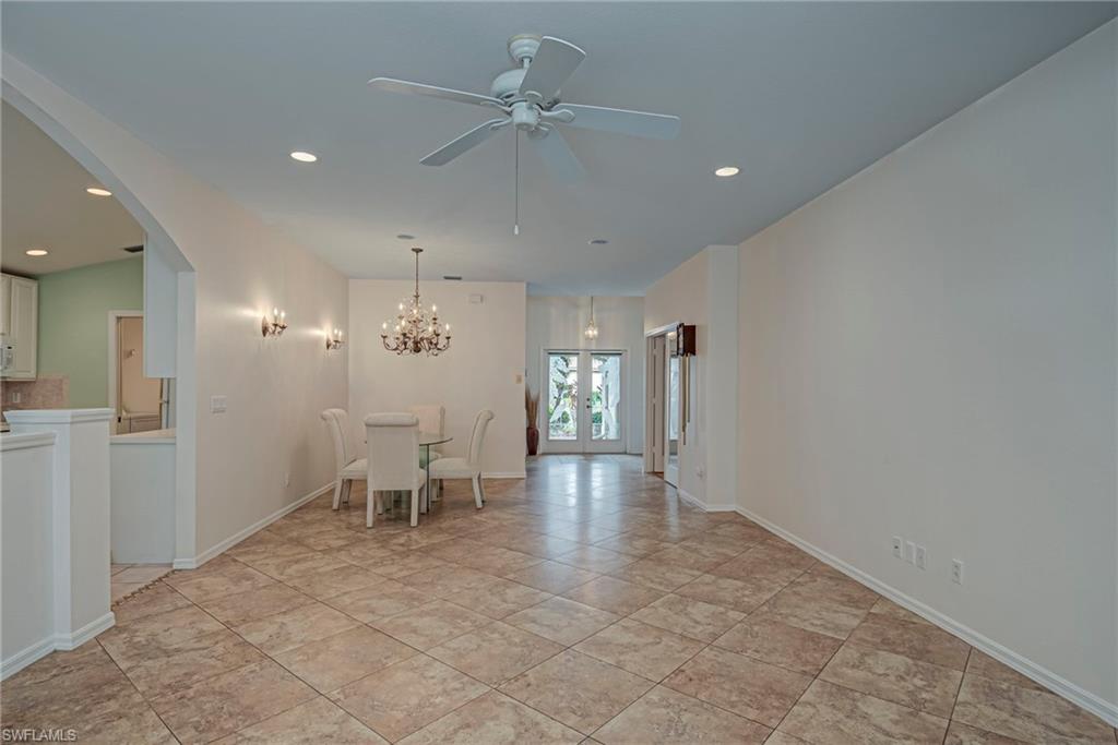 7809 Stratford Drive Naples, FL 34104 - Photo 4 of 47 wooden floor in an empty room with a window