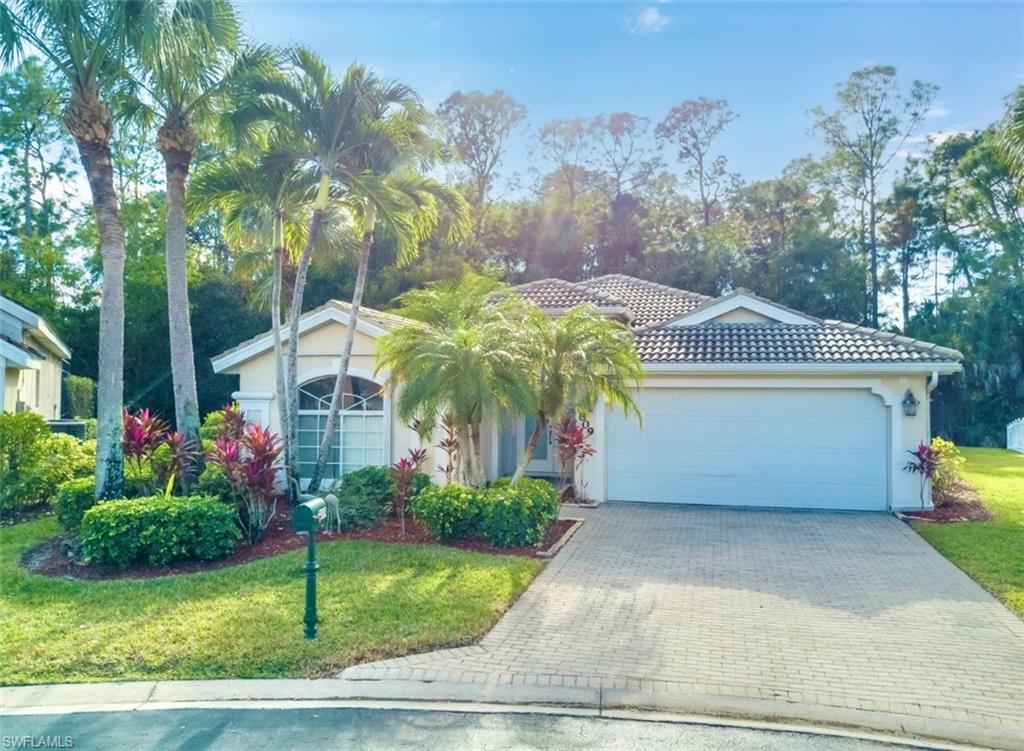 7809 Stratford Drive Naples, FL 34104 - Photo 41 of 47 a front view of a house with garden