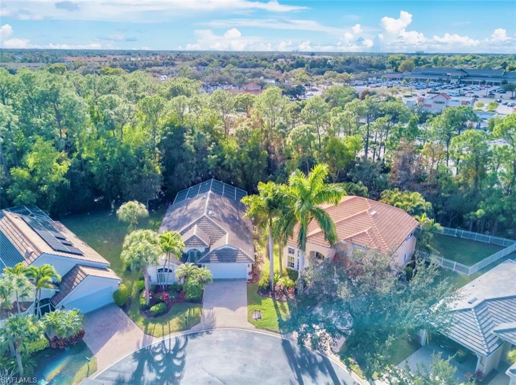 7809 Stratford Drive Naples, FL 34104 - Photo 43 of 47 a view of a garden with a lot of flower plants and wooden fence