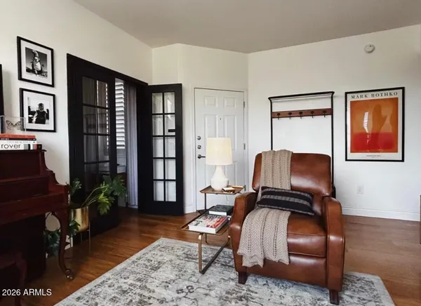 a living room with furniture rug and wooden floor