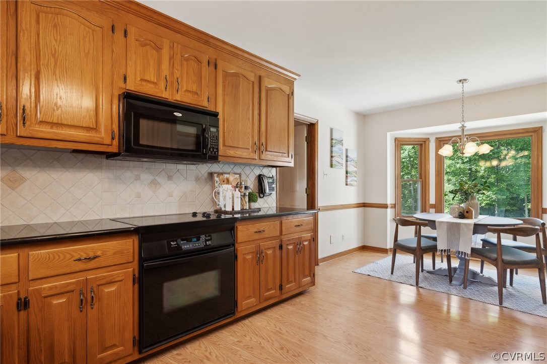 13200 River Road Chesterfield, VA 23838 - Photo 12 of 50 a kitchen with stainless steel appliances granite countertop a stove top oven a sink dishwasher a dining table and chairs with wooden floor