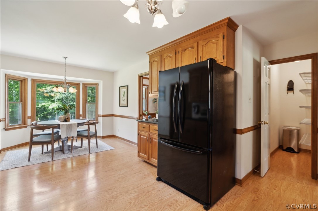 13200 River Road Chesterfield, VA 23838 - Photo 13 of 50 a kitchen with stainless steel appliances granite countertop a refrigerator a stove and a dining table with wooden floor