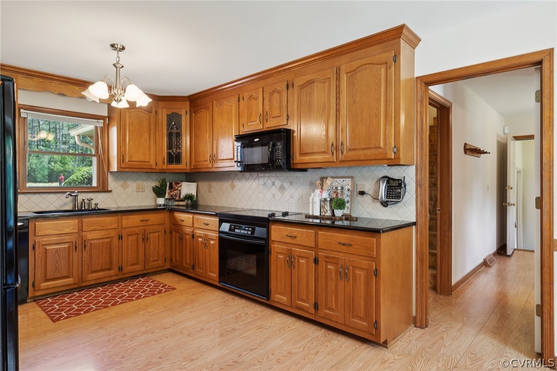 13200 River Road Chesterfield, VA 23838 - Photo 16 of 50 a kitchen with stainless steel appliances granite countertop wooden cabinets a sink and a stove