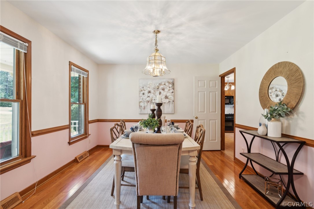 13200 River Road Chesterfield, VA 23838 - Photo 18 of 50 a dining room with furniture a potted plant and a chandelier
