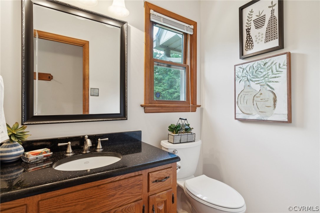 13200 River Road Chesterfield, VA 23838 - Photo 20 of 50 a bathroom with a granite countertop toilet a sink and a mirror
