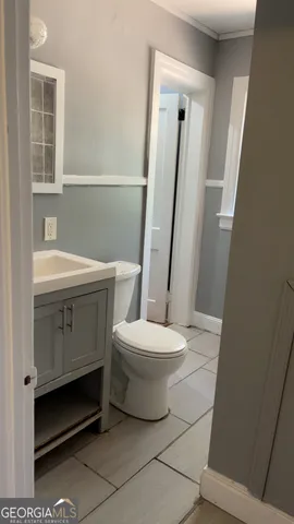 a bathroom with a toilet a sink and a mirror