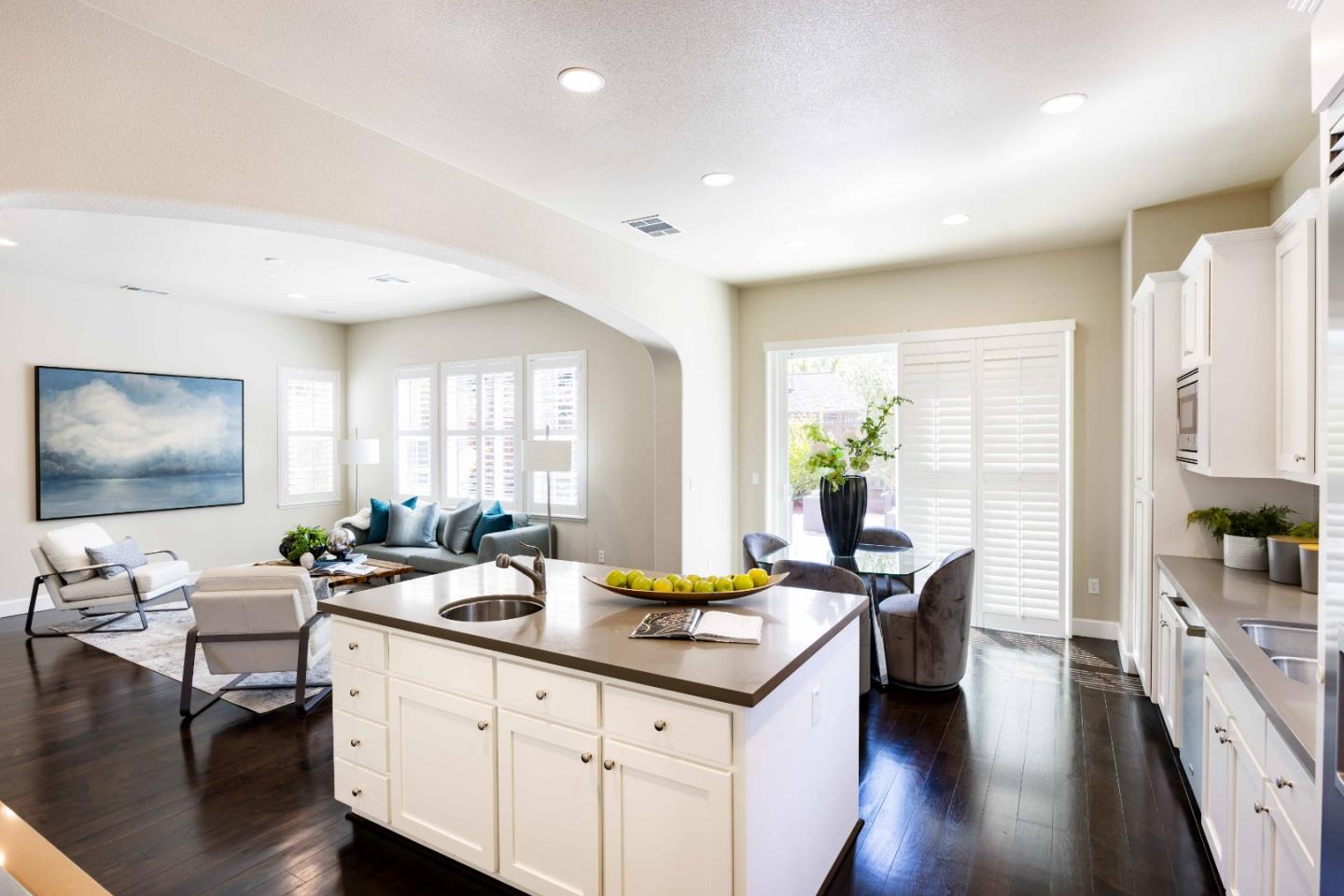 1400 Marigold Court Mountain View, CA 94040 - Photo 8 of 24 a living room with granite countertop couches a coffee table and flat screen tv