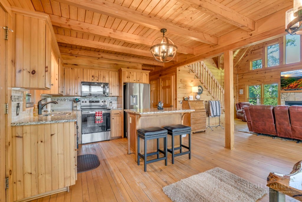 2229 Elk Ridge Road Ferguson, NC 28624 - Photo 11 of 42 a view of a dining room with furniture and wooden floor