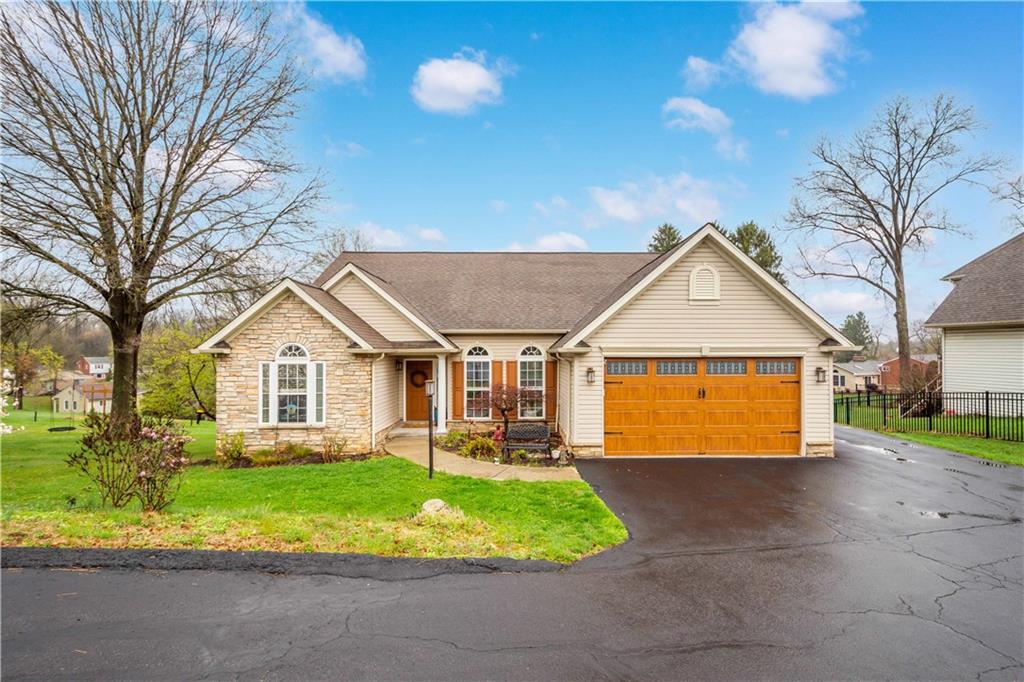 a front view of a house with a garden and plants
