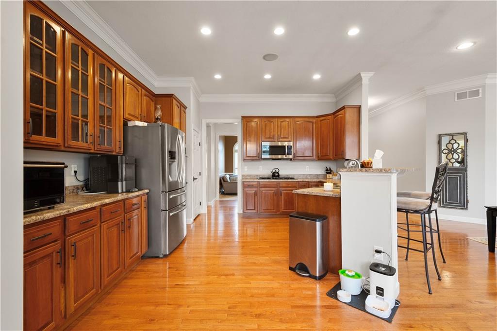 357 McMurray Road Pittsburgh, PA 15241 - Photo 15 of 46 a large kitchen with stainless steel appliances kitchen island granite countertop a refrigerator and a stove top oven