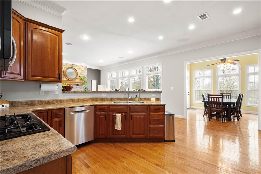 357 McMurray Road Pittsburgh, PA 15241 - Photo 18 of 46 a large kitchen with stainless steel appliances granite countertop a stove and a view of living room