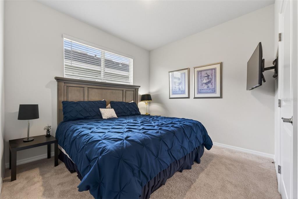 18237 Beach Ranch Terrace Bradenton, FL 34211 - Photo 25 of 72 a bedroom with a bed a wall painting and a window