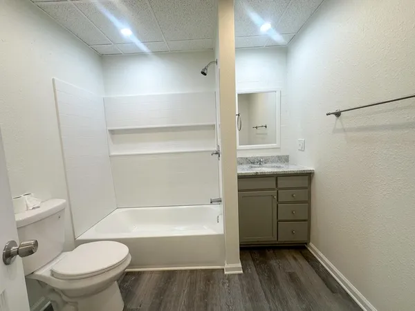 a bathroom with a sink toilet and shower