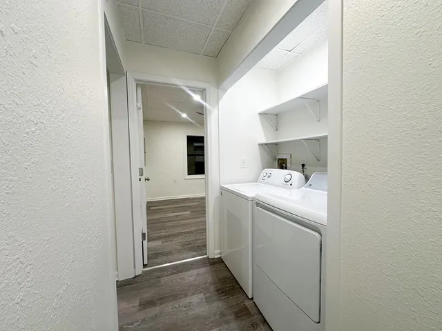 a utility room with cabinets washer and dryer