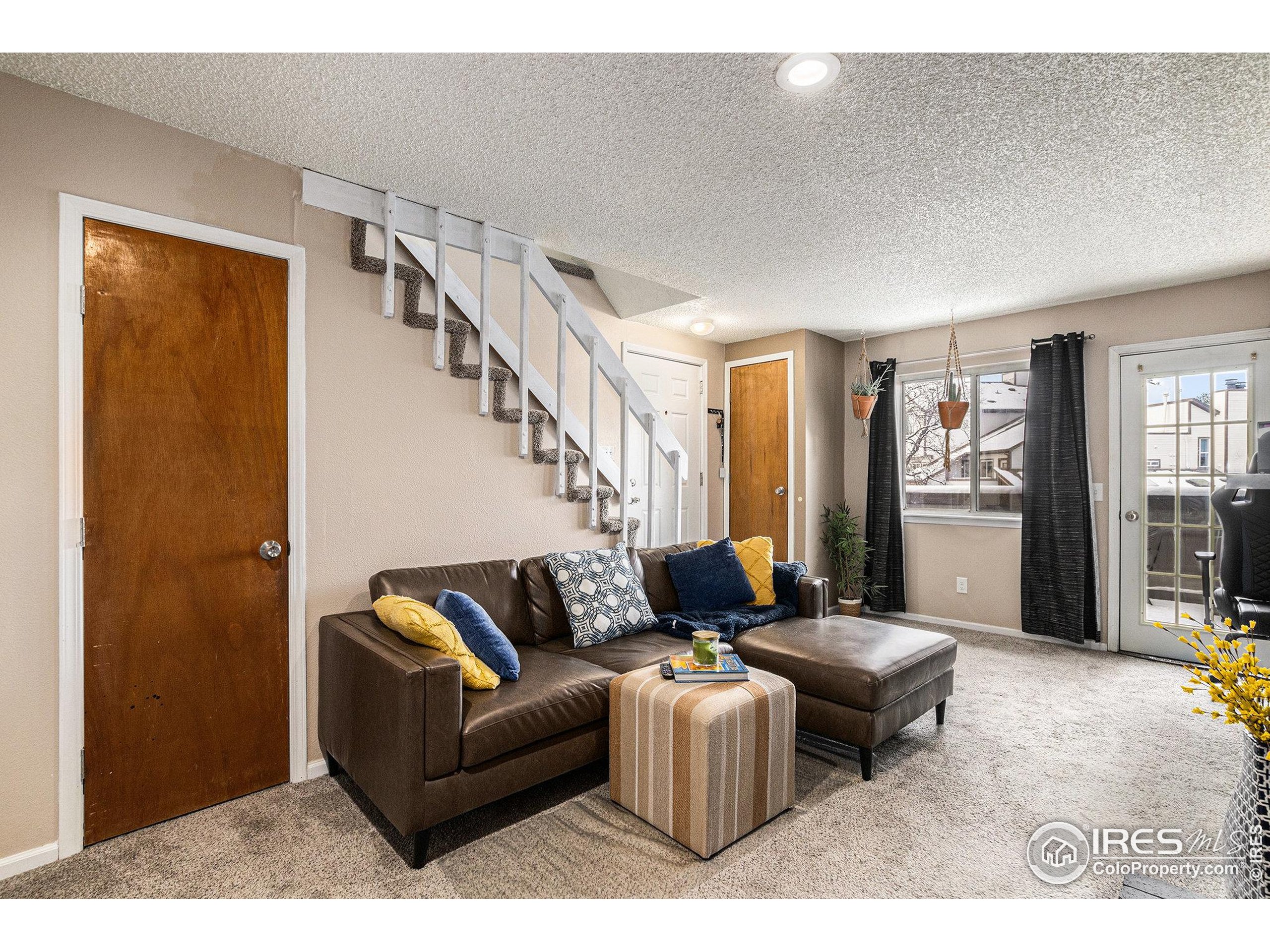 4911 Garrison Street, Unit 206G Wheat Ridge, CO 80033 - Photo 13 of 20 a living room with furniture and wooden floor