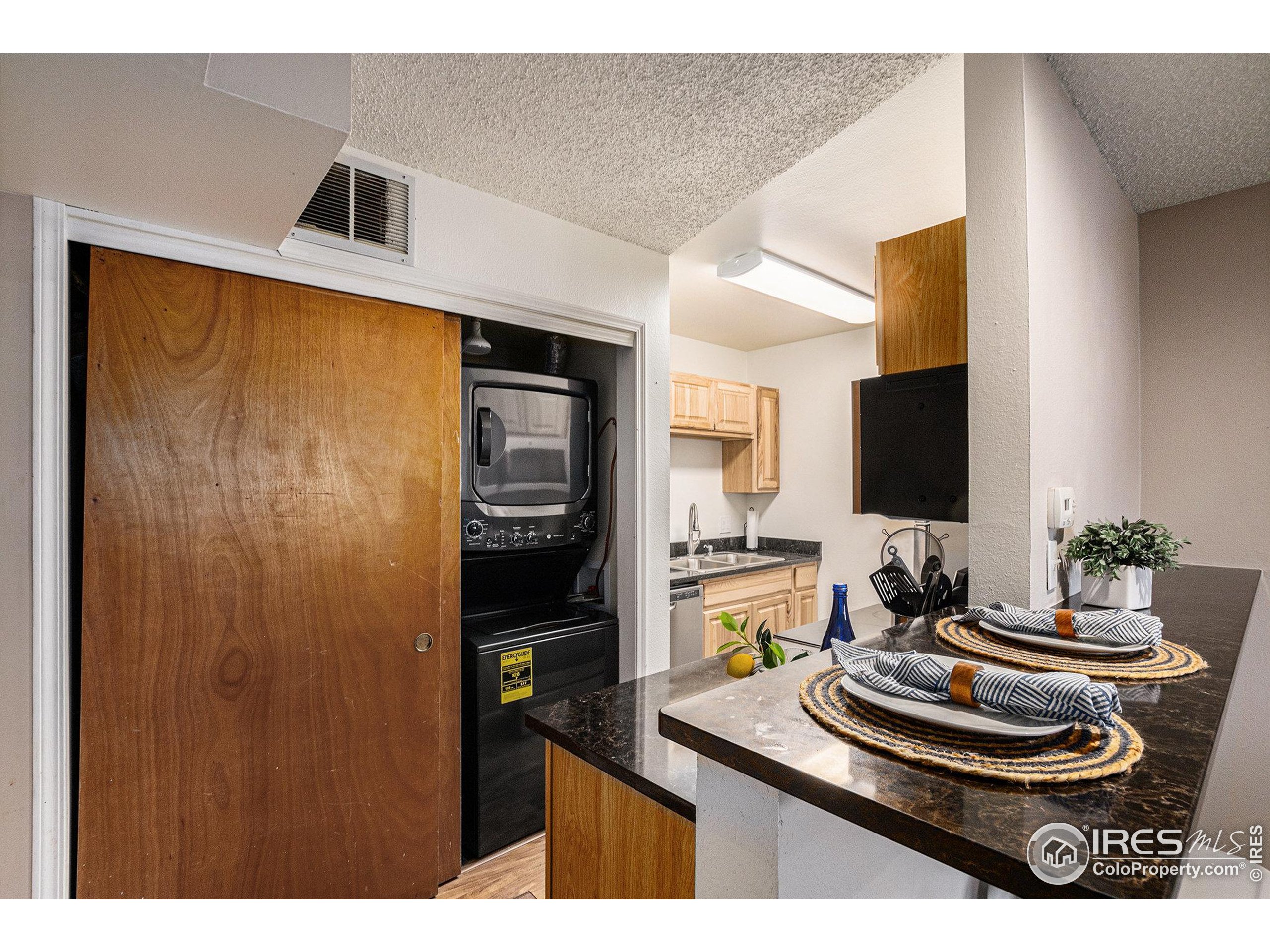 4911 Garrison Street, Unit 206G Wheat Ridge, CO 80033 - Photo 16 of 20 a room with furniture and a flat screen tv