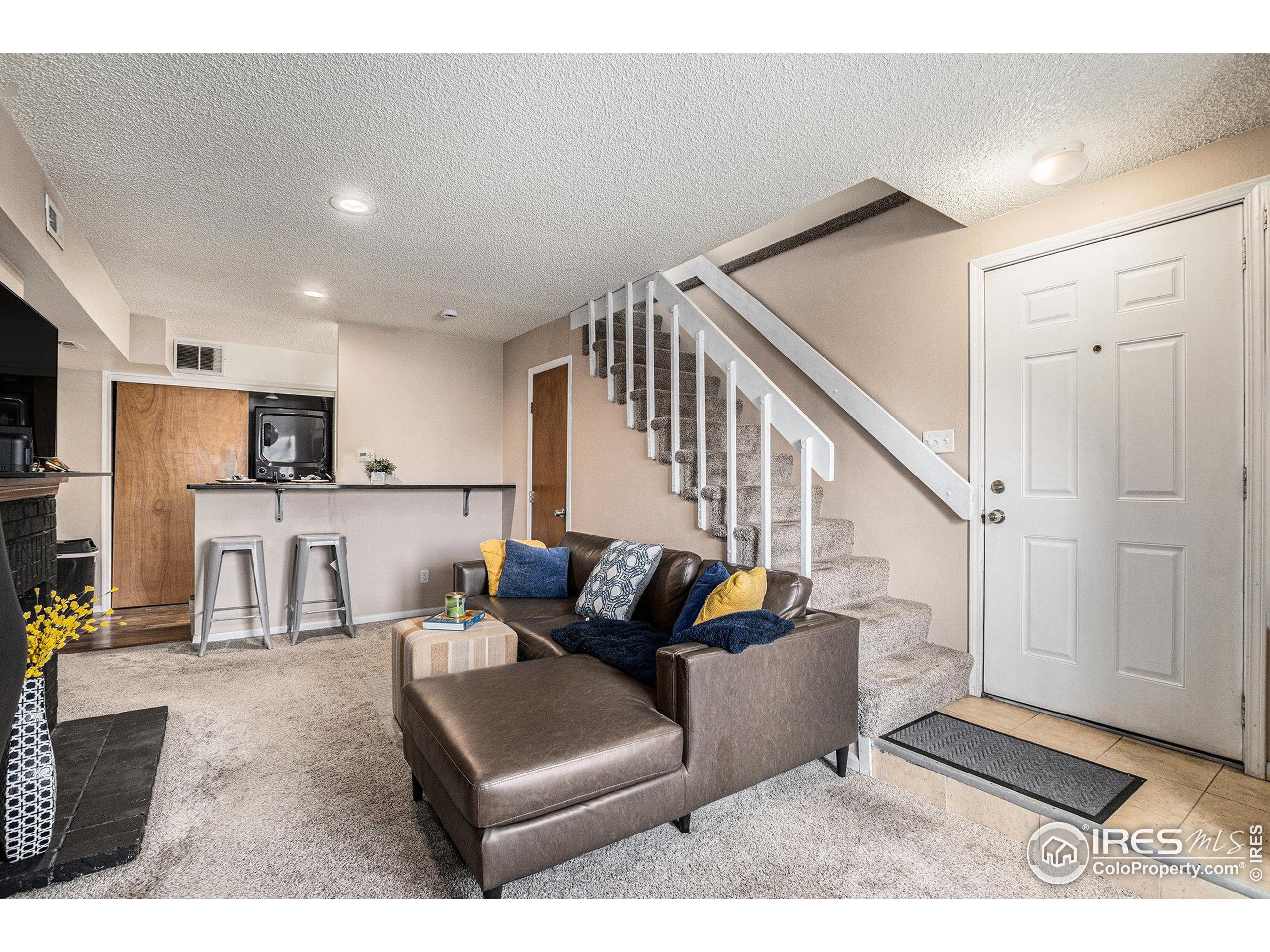 4911 Garrison Street, Unit 206G Wheat Ridge, CO 80033 - Photo 4 of 20 a living room with furniture and wooden floor