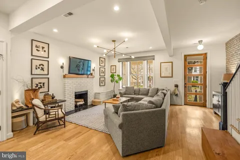 a living room with furniture a fireplace and a flat screen tv