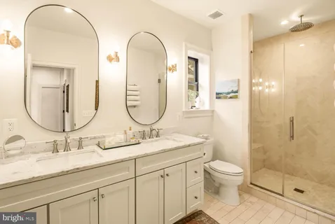 a view of a hallway with paintings on the wall
