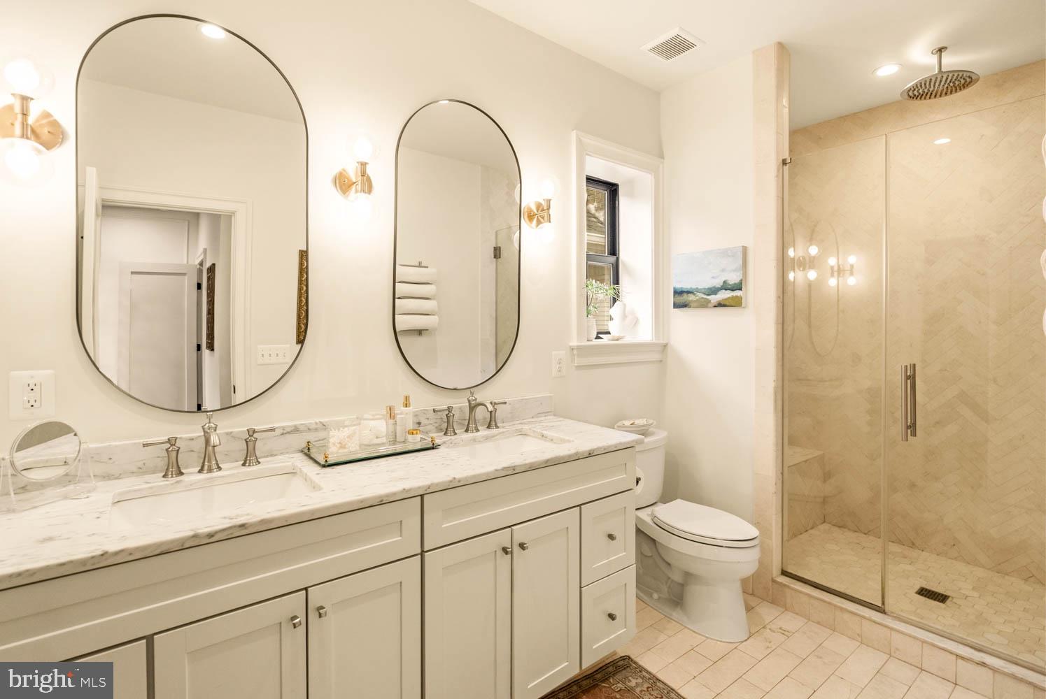 5711 Colorado Avenue Northwest Washington, DC 20011 - Photo 19 of 44 a bathroom with a double vanity sink toilet and shower