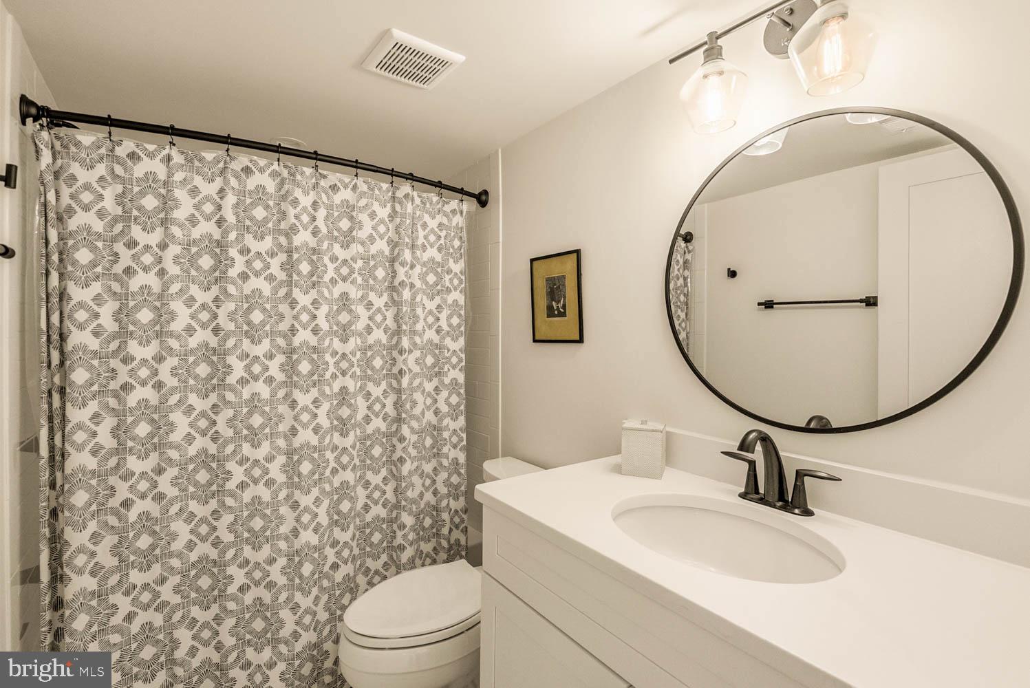 5711 Colorado Avenue Northwest Washington, DC 20011 - Photo 32 of 44 a bathroom with a sink toilet and mirror