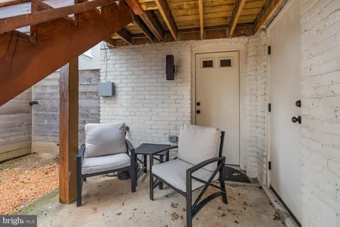 a view of a patio with couches and a fire pit