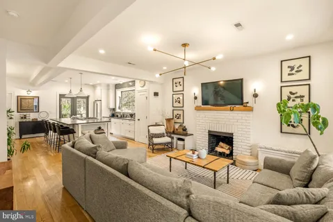 a living room with furniture fireplace and flat screen tv