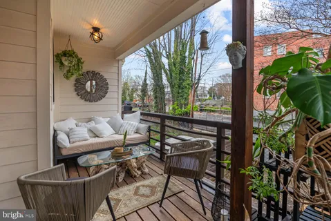 a balcony with furniture and potted plants