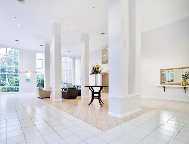 a living room with furniture and large windows