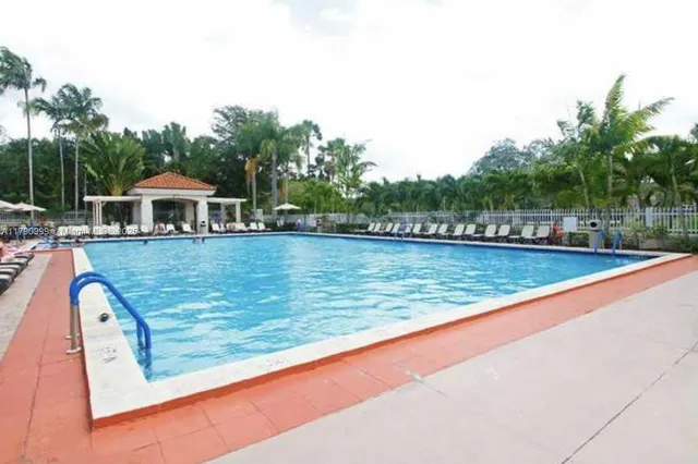 swimming pool view with a garden space