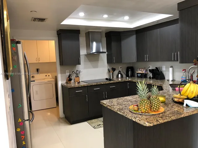 a kitchen with a sink appliances and cabinets
