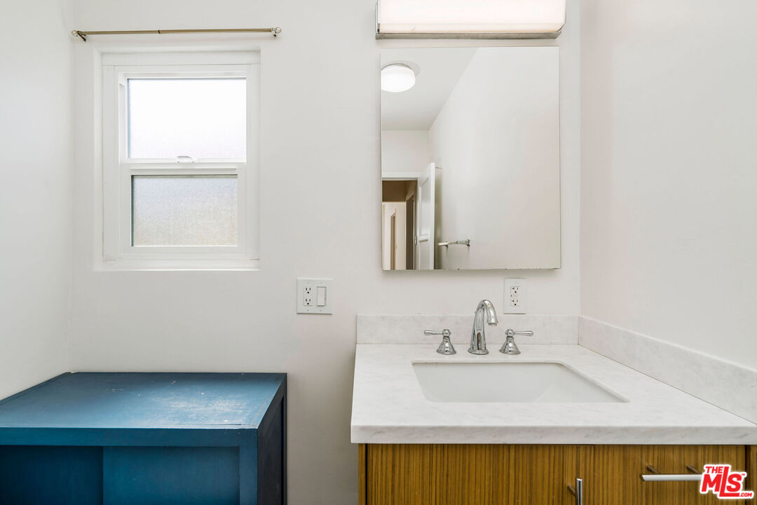 1215 North Avon Street Burbank, CA 91505 - Photo 20 of 37 a bathroom with a sink and a mirror
