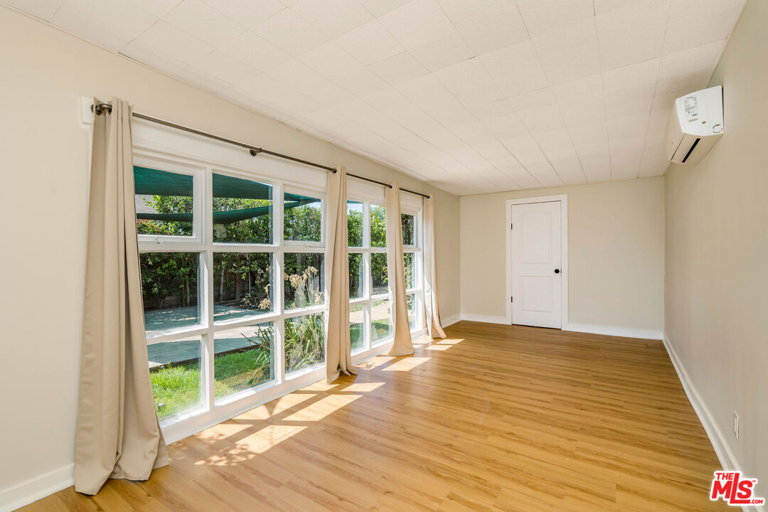1215 North Avon Street Burbank, CA 91505 - Photo 24 of 37 a view of an empty room with a window and wooden floor