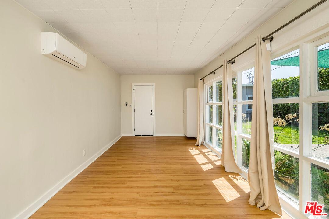 1215 North Avon Street Burbank, CA 91505 - Photo 25 of 37 a view of an empty room with wooden floor and windows