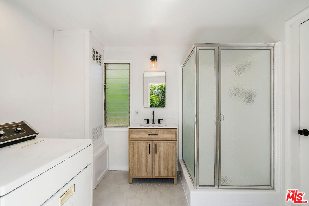 1215 North Avon Street Burbank, CA 91505 - Photo 26 of 37 a room with a sink and a mirror