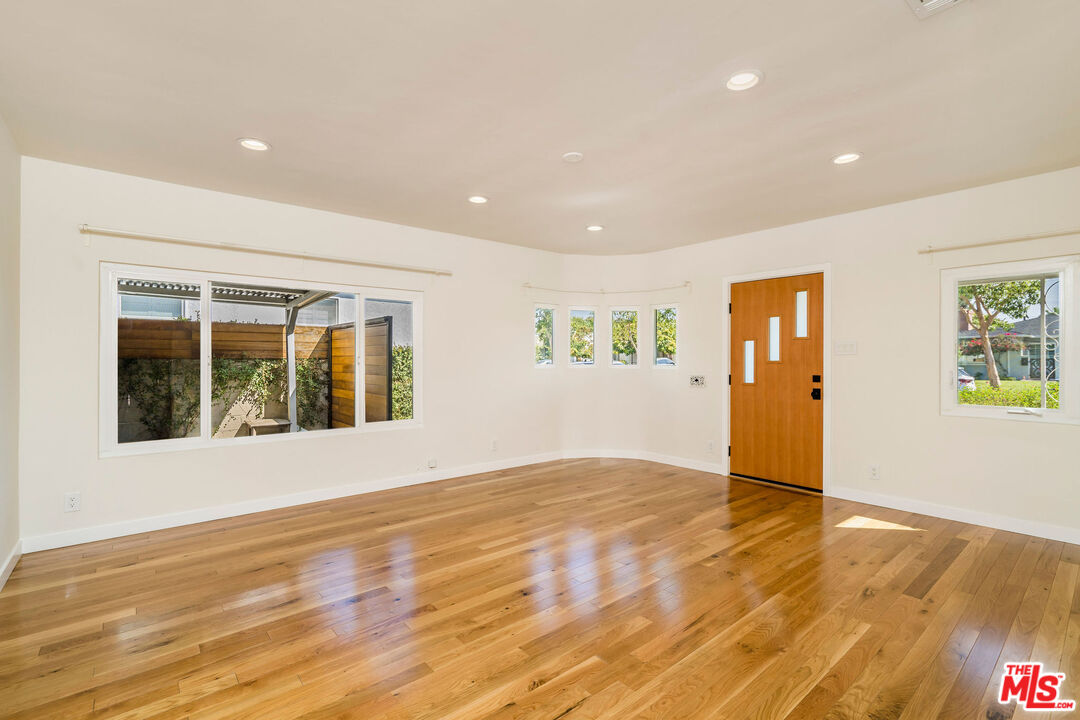 1215 North Avon Street Burbank, CA 91505 - Photo 6 of 37 a view of an empty room with wooden floor and a window