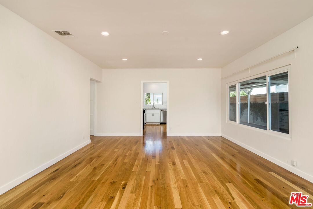 1215 North Avon Street Burbank, CA 91505 - Photo 7 of 37 a view of empty room with wooden floor and fan
