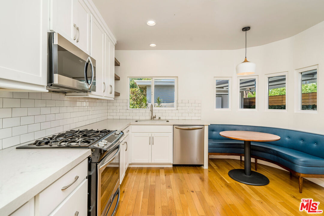 1215 North Avon Street Burbank, CA 91505 - Photo 9 of 37 a kitchen with a sink stove and microwave